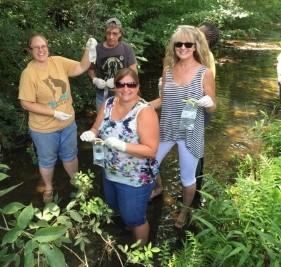 Volunteers collecting water samples for bacterial testing