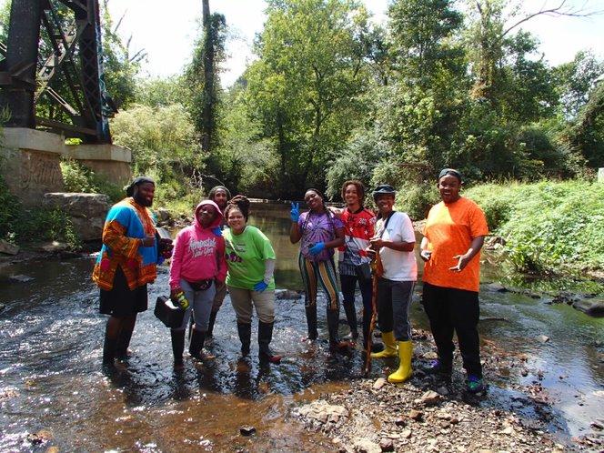 A group photo of volunteers in the stream before monitoring.